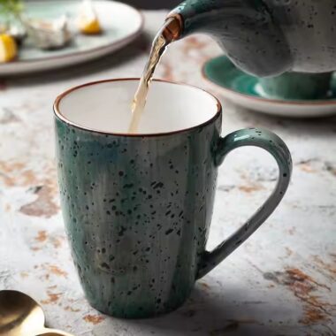 Handmade retro-style ceramic mug with colorful glazed finish