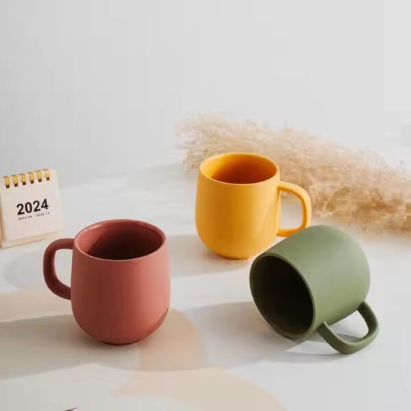 Handmade colorful clay ceramic mug with artistic texture