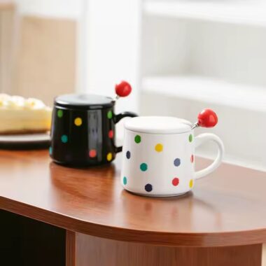 Colorful polka dot ceramic mug with lid and spoon for tea or coffee