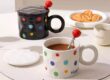 Colorful polka dot ceramic mug with lid and spoon for tea or coffee