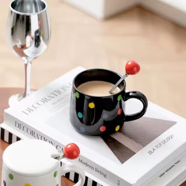 Colorful polka dot ceramic mug with lid and spoon for tea or coffee