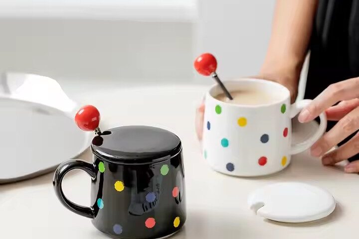 Colorful polka dot ceramic mug with lid and spoon for tea or coffee