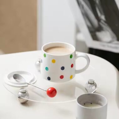 Colorful polka dot ceramic mug with lid and spoon for tea or coffee