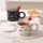 Colorful polka dot ceramic mug with lid and spoon for tea or coffee