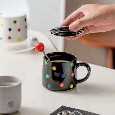 Colorful polka dot ceramic mug with lid and spoon for tea or coffee
