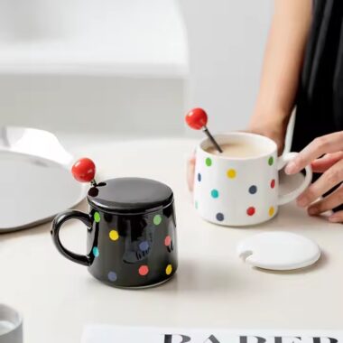 Colorful polka dot ceramic mug with lid and spoon for tea or coffee