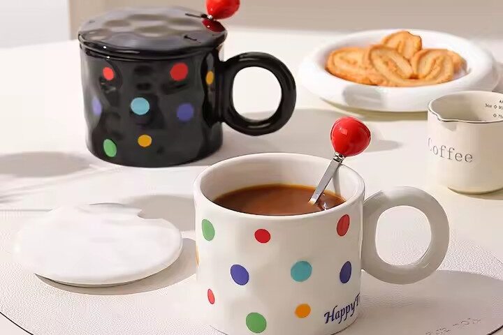 Colorful polka dot ceramic mug with lid and spoon for tea or coffee