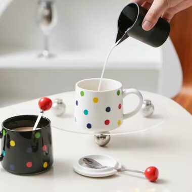 Colorful polka dot ceramic mug with lid and spoon for tea or coffee
